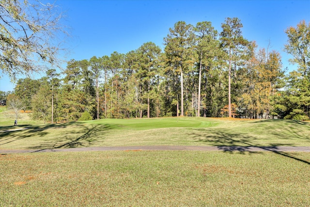 surrounding community with a lawn and golf course view