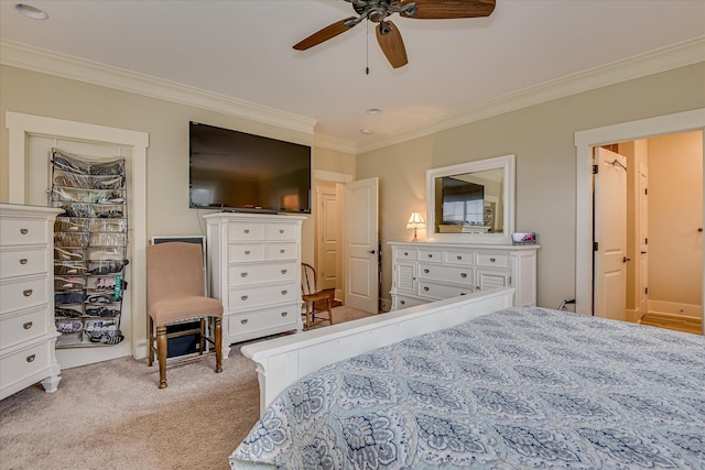 carpeted bedroom featuring a ceiling fan and ornamental molding
