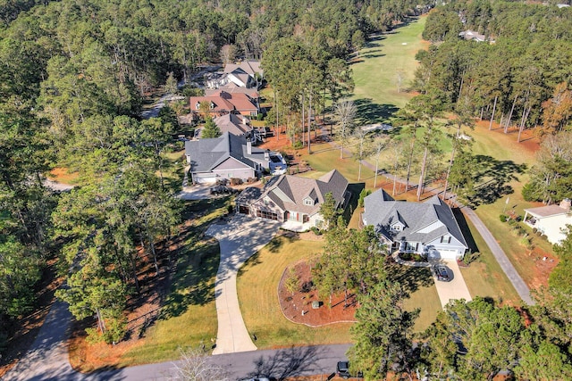 drone / aerial view with a residential view and a wooded view