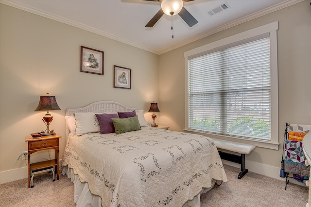 bedroom featuring baseboards, visible vents, carpet floors, and crown molding