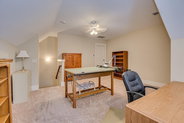 carpeted home office with ceiling fan, lofted ceiling, visible vents, and baseboards