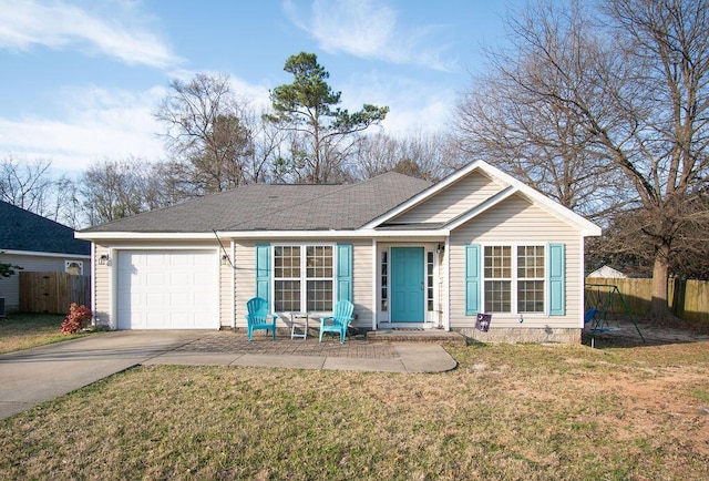 ranch-style home featuring a garage, a front yard, concrete driveway, and fence