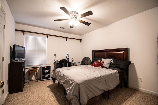 bedroom featuring baseboards, ceiling fan, a textured ceiling, and light colored carpet