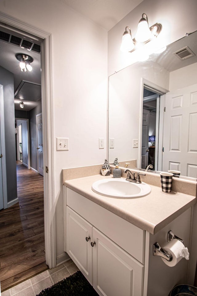 bathroom featuring visible vents, wood finished floors, and vanity