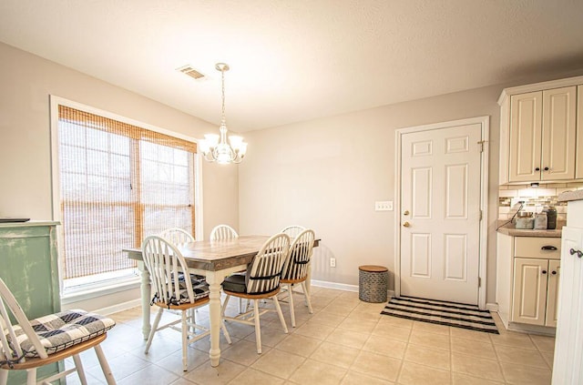 dining room with visible vents, plenty of natural light, a notable chandelier, and baseboards