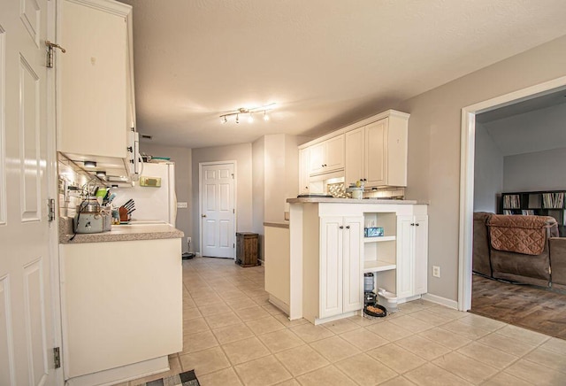 kitchen featuring open shelves, light tile patterned floors, white cabinets, and light countertops