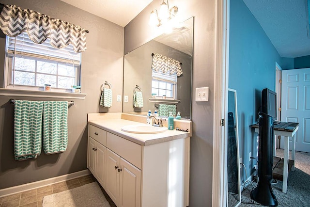 bathroom featuring vanity and baseboards