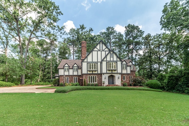 506 Regent Pl, Augusta, GA 30909 - english style home with a chimney, a front lawn, brick siding, and stucco siding