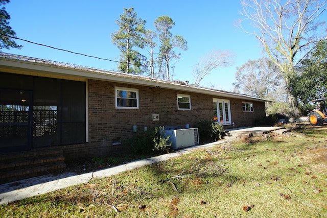 rear view of house with french doors and central air condition unit