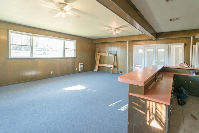 interior space featuring ceiling fan and beamed ceiling