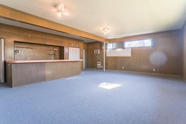 interior space featuring carpet, a wall mounted air conditioner, and wooden walls