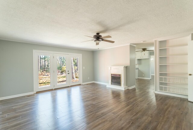unfurnished living room featuring ceiling fan, crown molding, dark hardwood / wood-style floors, and a textured ceiling