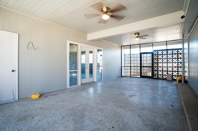 unfurnished room featuring beamed ceiling, ceiling fan, and french doors