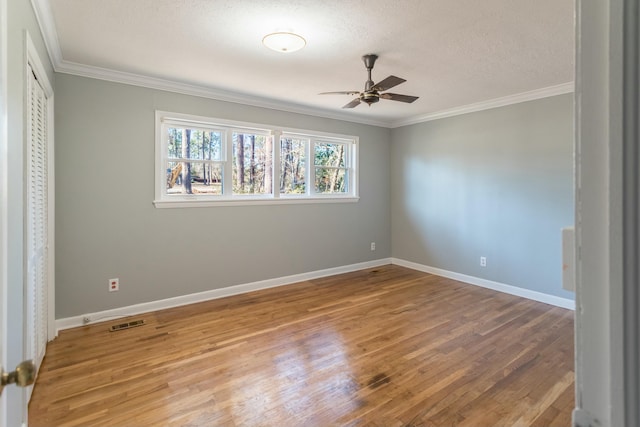 unfurnished bedroom featuring hardwood / wood-style floors, a textured ceiling, ceiling fan, and ornamental molding