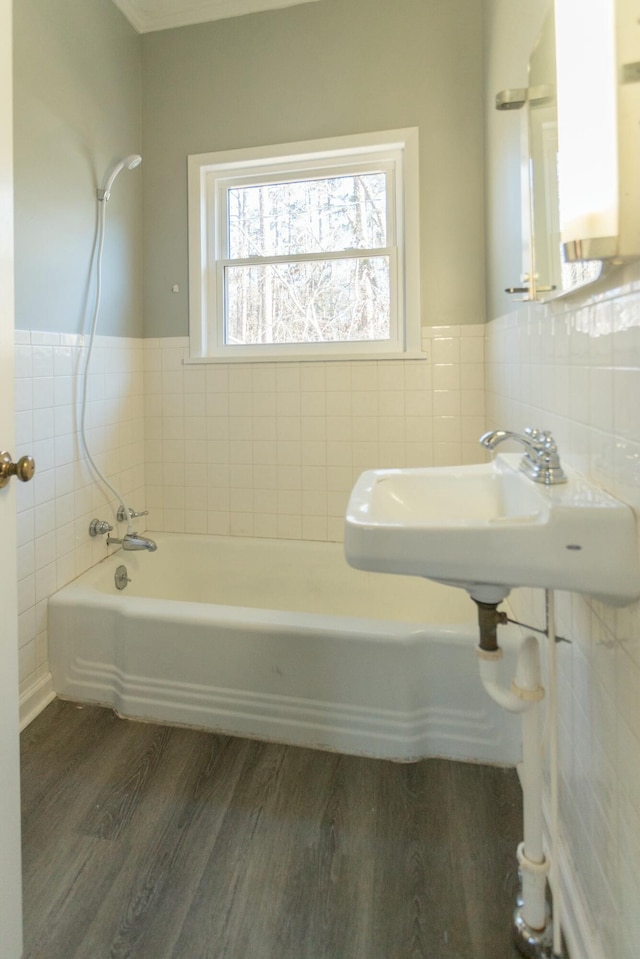 bathroom with sink, shower / washtub combination, and hardwood / wood-style flooring