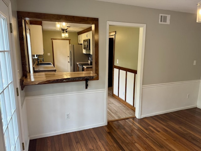 3777 Pine Ridge Run, Martinez, GA 30907 - kitchen featuring appliances with stainless steel finishes, dark wood finished floors, and white cabinets