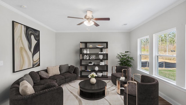 living room featuring a ceiling fan, wood finished floors, baseboards, and ornamental molding