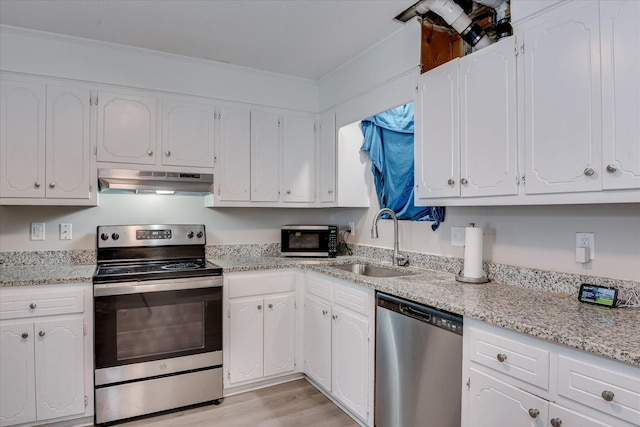 2904 Pleasant Ct, Augusta, GA 30907 - kitchen with stainless steel appliances, exhaust hood, white cabinetry, and light wood finished floors