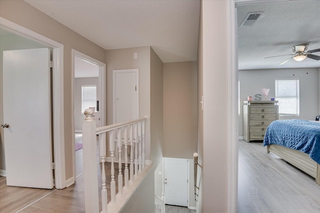 2904 Pleasant Ct, Augusta, GA 30907 - hall with an upstairs landing, light wood finished floors, and a textured ceiling
