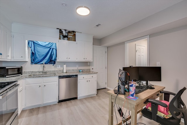 2904 Pleasant Ct, Augusta, GA 30907 - kitchen with appliances with stainless steel finishes, light wood finished floors, white cabinetry, light stone countertops, and a desk