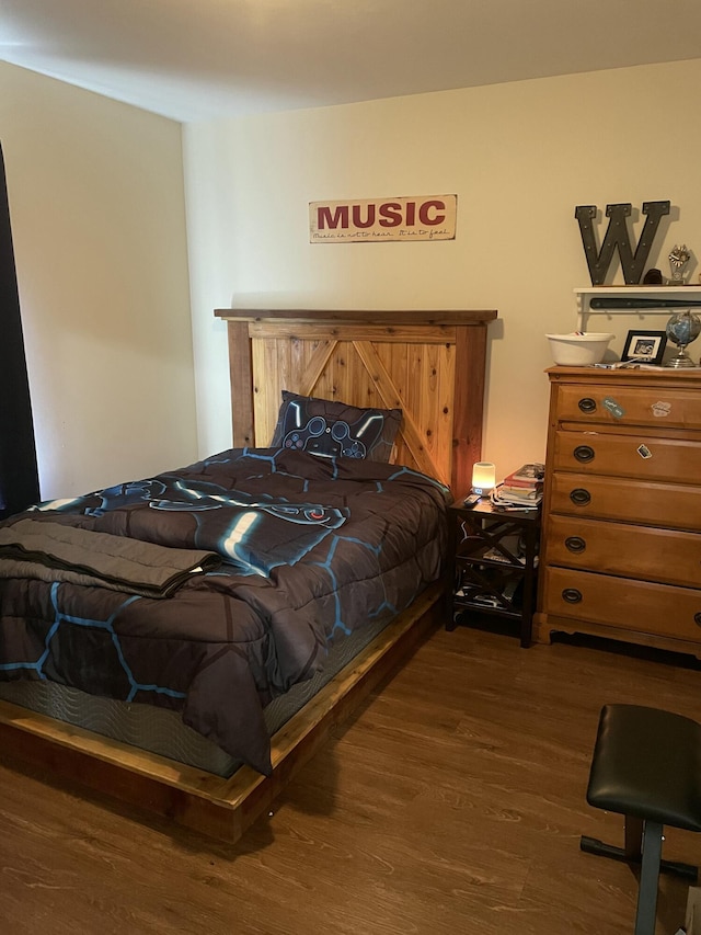 bedroom with dark wood-type flooring