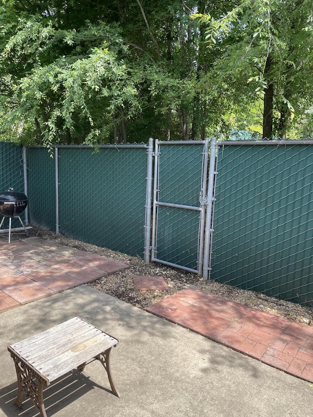 view of gate with a patio area and fence