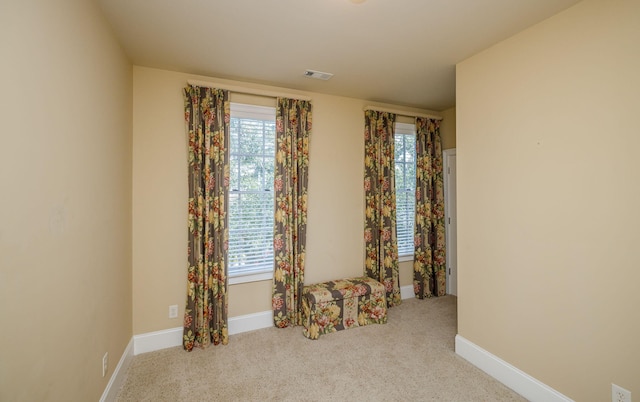 empty room featuring light carpet