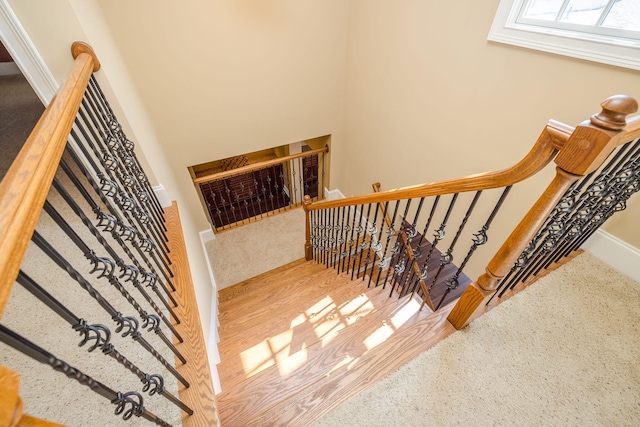 stairs featuring hardwood / wood-style floors