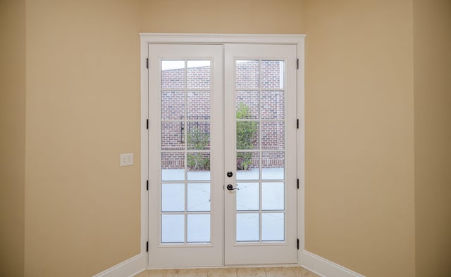 doorway to outside with french doors and light tile patterned floors