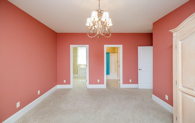 spare room with an inviting chandelier