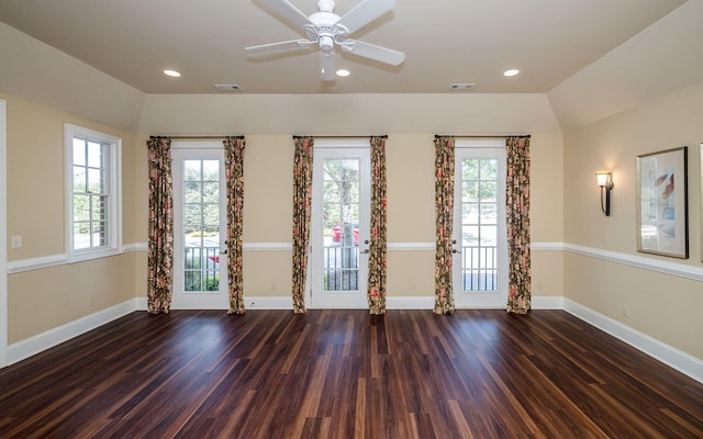 empty room with dark wood-type flooring, ceiling fan, and lofted ceiling