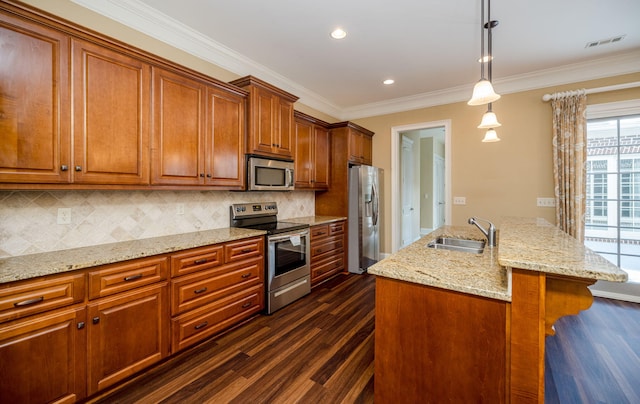 kitchen featuring pendant lighting, sink, ornamental molding, tasteful backsplash, and stainless steel appliances