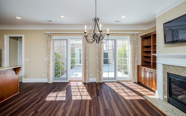 interior space featuring built in shelves, a premium fireplace, crown molding, and dark hardwood / wood-style floors