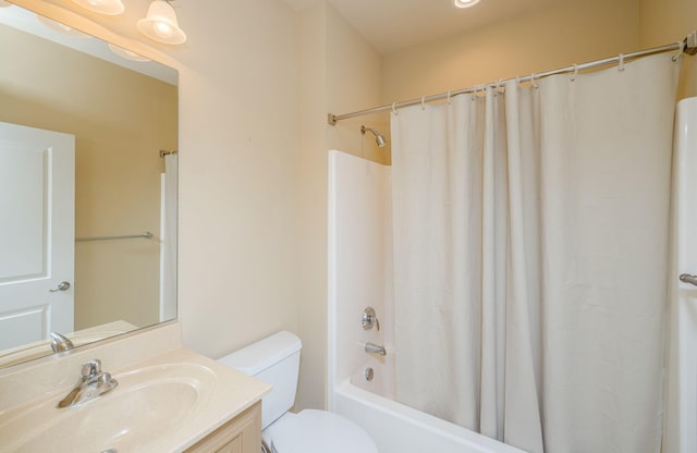 full bathroom featuring shower / bath combo, vanity, and toilet