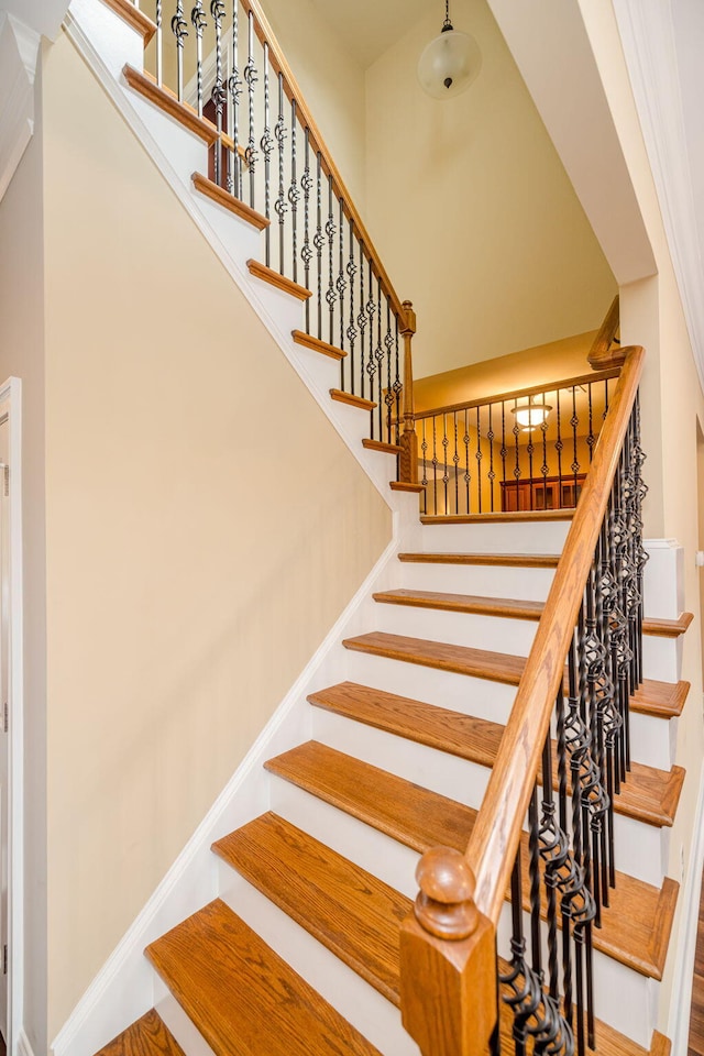 stairway featuring ornamental molding