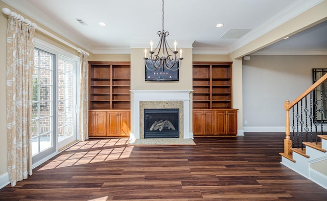 living room with built in shelves, an inviting chandelier, dark wood-type flooring, and ornamental molding