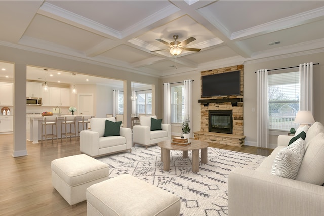 living room featuring beam ceiling, light wood-style floors, visible vents, and coffered ceiling