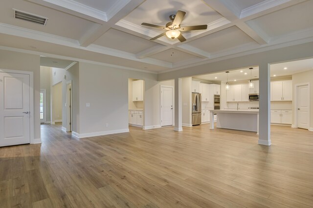 unfurnished living room with beam ceiling, light wood-style floors, visible vents, and coffered ceiling