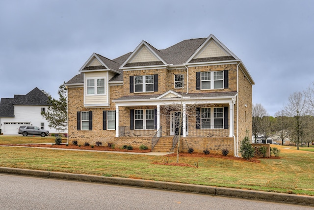 craftsman house featuring a front yard, a porch, brick siding, and crawl space