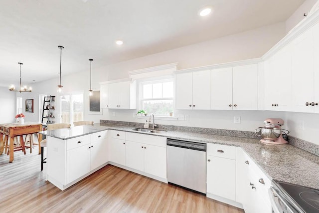 kitchen featuring stainless steel dishwasher, white cabinets, hanging light fixtures, and kitchen peninsula