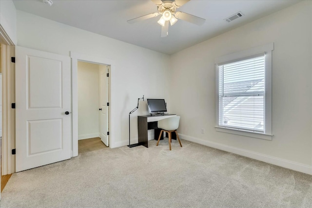 office space with a ceiling fan, carpet, visible vents, and baseboards