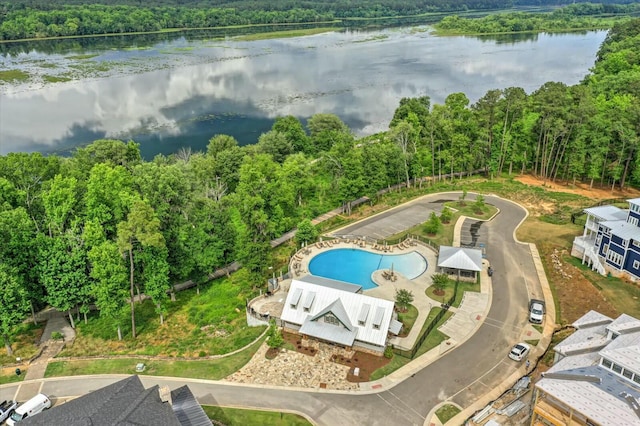 birds eye view of property with a forest view and a water view