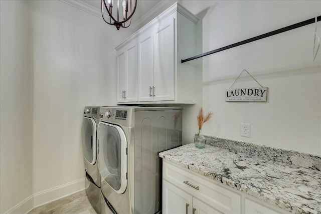 laundry room with crown molding, washer and clothes dryer, cabinet space, a chandelier, and baseboards