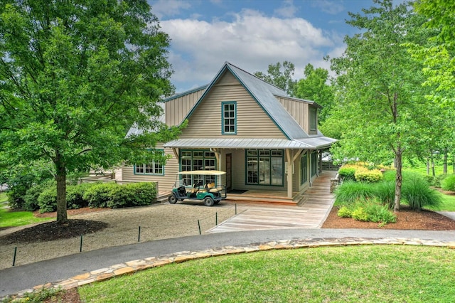 view of front facade featuring covered porch and metal roof