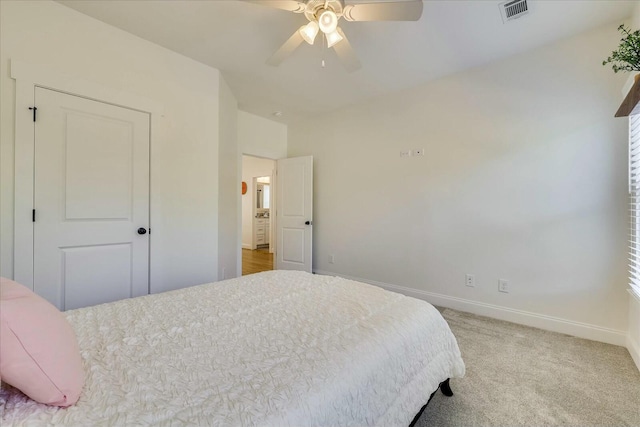 carpeted bedroom featuring ceiling fan, visible vents, and baseboards