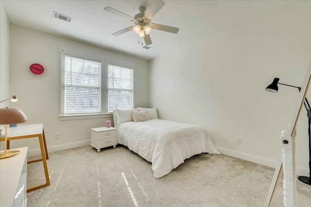 bedroom featuring a ceiling fan, light colored carpet, visible vents, and baseboards