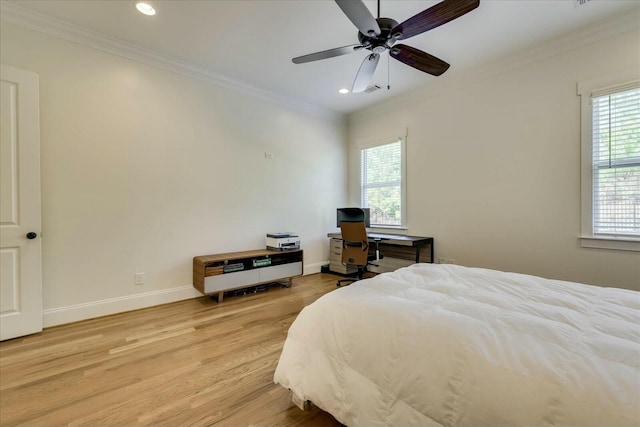 bedroom with multiple windows, crown molding, and light wood-style flooring