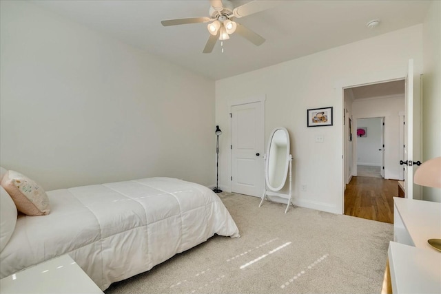 bedroom with carpet floors, ceiling fan, and baseboards