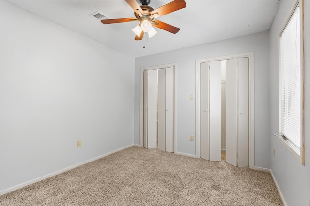 3252 Summerchase Cir, Augusta, GA 30909 - unfurnished bedroom featuring light carpet, two closets, baseboards, and ceiling fan