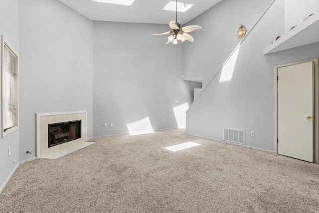 3252 Summerchase Cir, Augusta, GA 30909 - unfurnished living room with high vaulted ceiling, a skylight, carpet, stairs, and ceiling fan